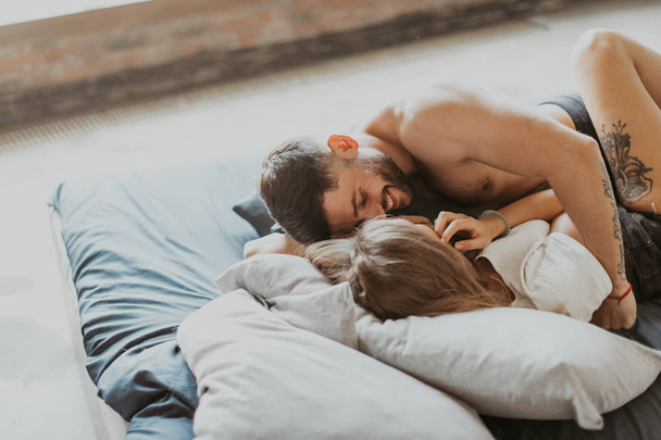 Beautiful couple kissing in bed - Foto, immagini