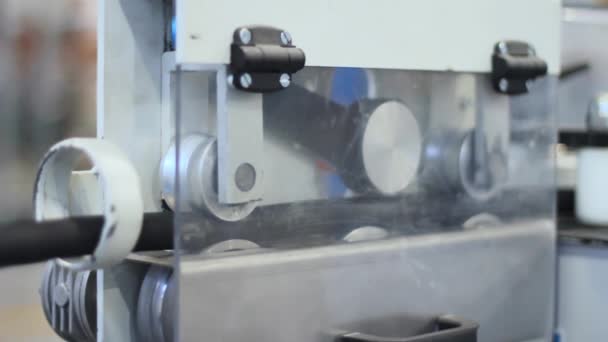Plastic hose passing conveyor on machine. Industrial equipment - Footage, Video
