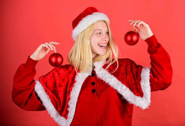 Lets decorate christmas tree. Favorite time year christmas. Enjoy celebration with costume and decor. Girl happy wear santa costume celebrate christmas hold ball decor. Christmas preparation concept - Фото, зображення