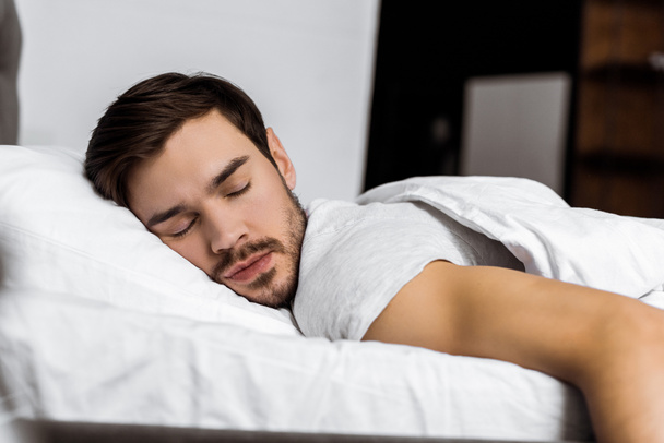 handsome bearded young man sleeping in bed at home  - Foto, Imagem