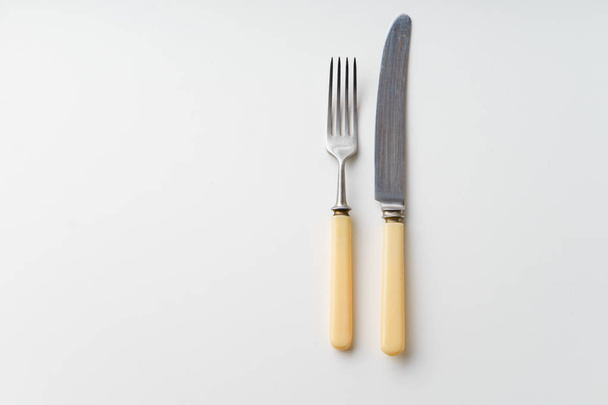 Vintage knife and fork isolated on white background, close-up  - 写真・画像