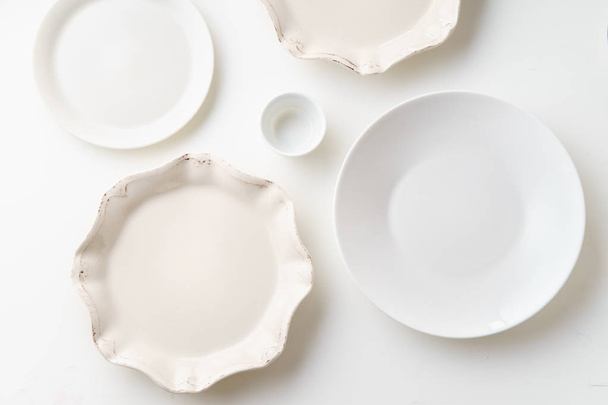 white empty porcelain plates isolated on white background, close-up  - Фото, изображение