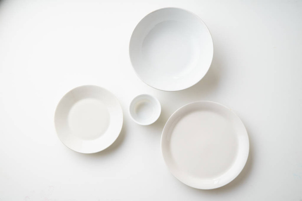 white empty porcelain plates isolated on white background, close-up  - Fotó, kép