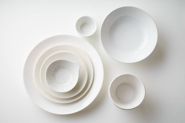 set of porcelain dishes isolated on white background, close-up  - Foto, Bild