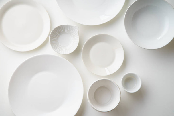 collection of porcelain plates isolated on white background, close-up  - 写真・画像
