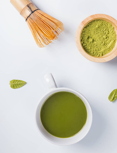Traditional japanese green tea matcha in a cup, whisk and powder - Photo, image
