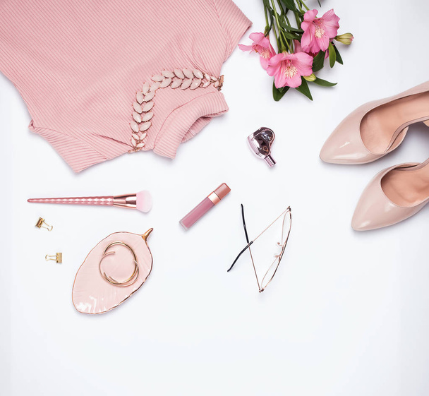 Stylish pale pink feminine accessories on the white background. - Фото, изображение