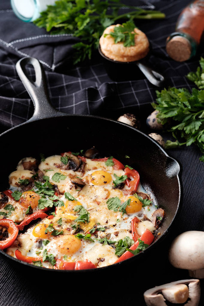 Fried eggs with bacon, mushrooms, bell peppers and greens - Photo, image