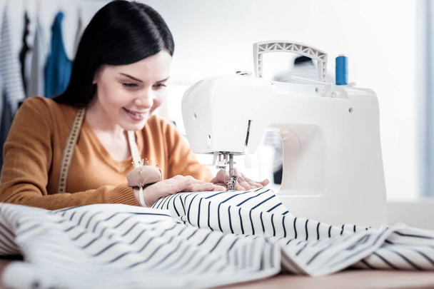 Modern sewing machine being used for work - Фото, зображення