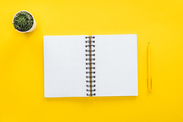 top view of blank spiral notebook and pen on yellow background - Photo, Image
