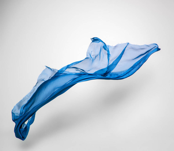 abstract piece of blue fabric flying, high-speed studio shot - Zdjęcie, obraz