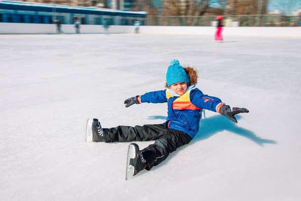 little boy enjoy skating on ice in winter nature - 写真・画像