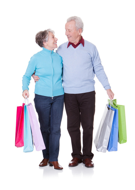 Senior Couple Holding Shopping Bags - Foto, afbeelding