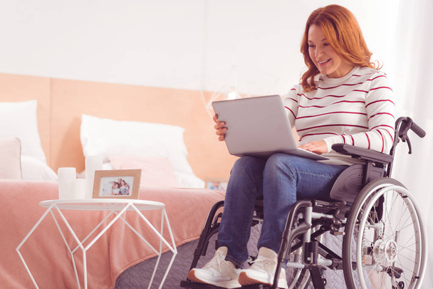 Positive disabled woman surfing the internet - Foto, imagen