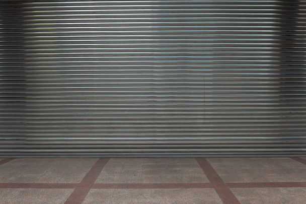 A closeup shot of automatic metal roller door used in factory, storage, garage, and industrial warehouse. The corrugated and foldable metal sheet offer space saving and provide urban and rustic feel - Photo, Image