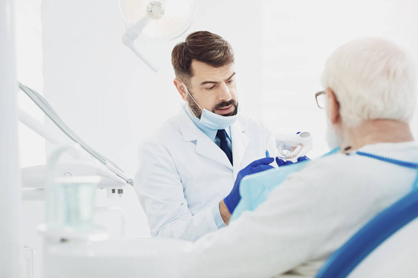 Earnest male dentists explaining details - Фото, зображення