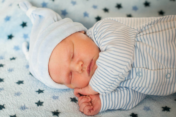 A newborn baby sleeping sweet on a blanket - Фото, изображение