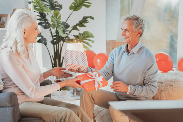 Senior woman and man exchanging gifts - Photo, image