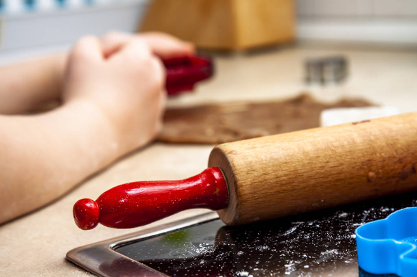 Little girl preparing a dough standing in the kitchen - Fotoğraf, Görsel