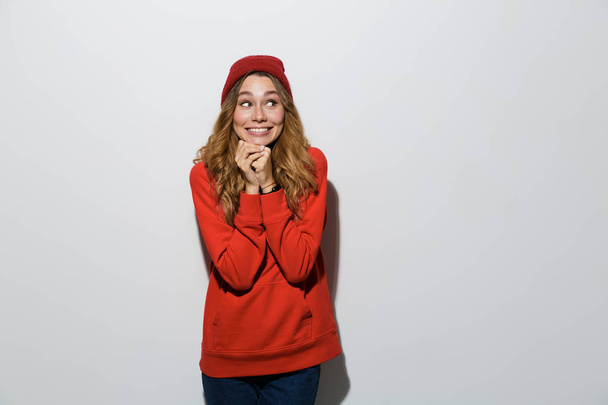 Photo of happy excited young woman posing isolated over grey wall background. - Foto, imagen