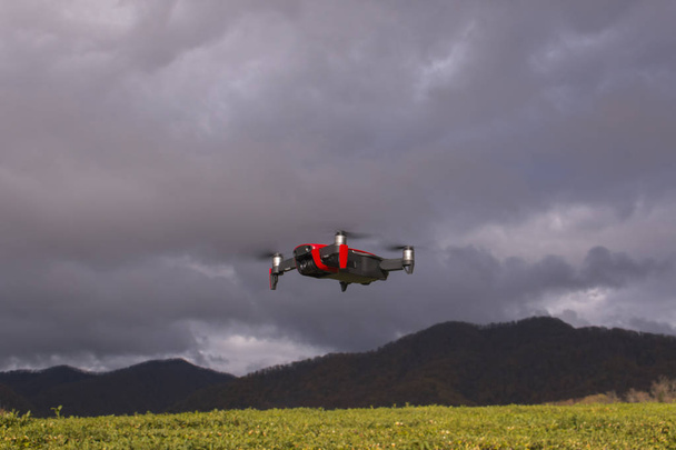 Drone Dji portret close-up. Fliyng drone onder de bewolkte hemel. - Foto, afbeelding