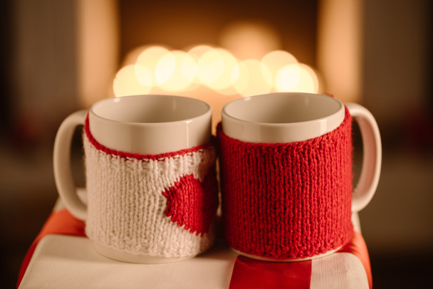 knitted mugs on glowing bokeh background - Photo, image