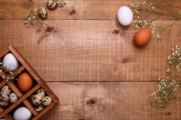 Eggs in wooden box on the table. Top view, copy space - Photo, image