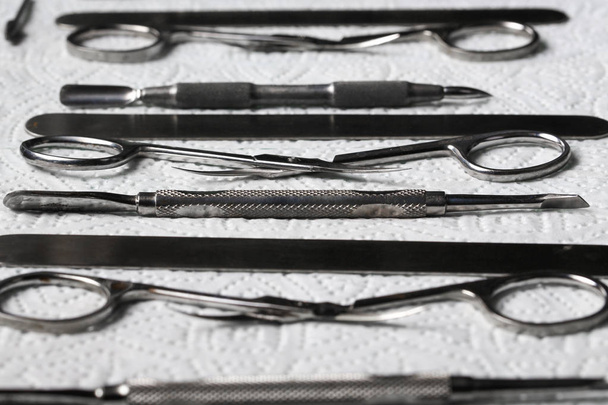 top view of manicure tools set of metallic tools on paper towel macro sterilization, disinfection. - Valokuva, kuva