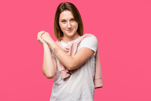 happy young woman with crossed hand palms looking at camera isolated on pink - Photo, Image