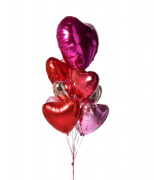 Bunch of metallic red pink heart balloons composition objects for birthday or valentines party isolated on a white  - Foto, Imagen