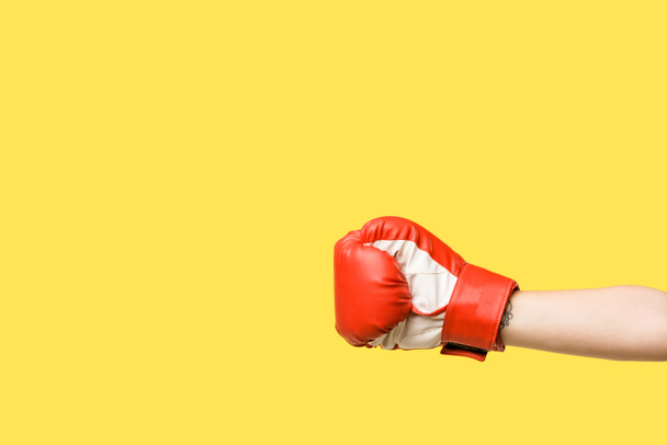 cropped shot of girl wearing boxing glove isolated on yellow - Foto, immagini
