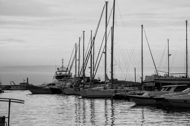 yacht bay on amazing backgrount with city and mountains at sunset. Black and white image - Fotografie, Obrázek