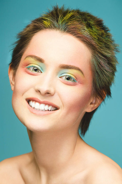 Close-up portrait of a woman with brightly colored hair and rainbow-like makeup. Multi-colored hair, beautiful lips and makeup. Short haircut. Sexy girl with short hair - Photo, Image