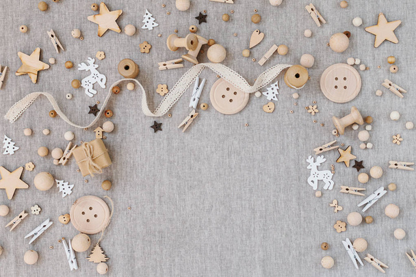 Craft and wooden Christmas flatlay on farbic background. Wooden supplies, cotton lace and christmas symbols. Place for text - Fotografie, Obrázek