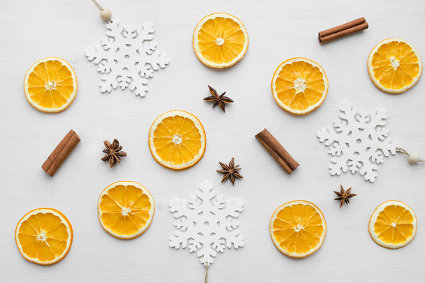 composition with dry oranges, cinnamon sticks, anise stars and wooden snowflakes - Φωτογραφία, εικόνα