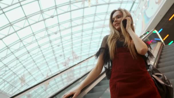 woman using smartphone in shopping mall close up shot 4K stock video - Materiaali, video