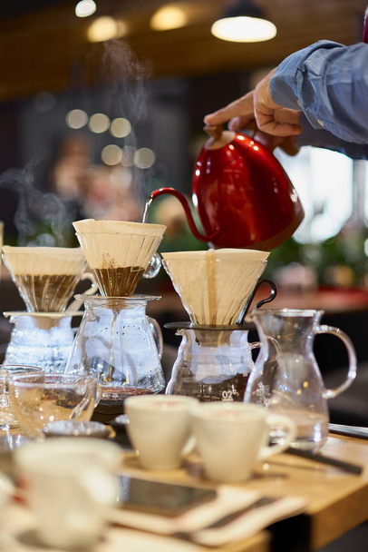 Barista pouring water into cup of ground coffee on scale - Foto, immagini
