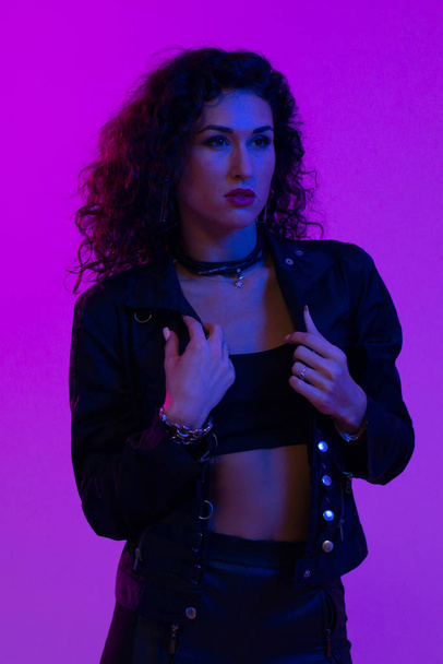 Portrait of beautiful woman. Pink, purple and blue light colors. - Photo, Image