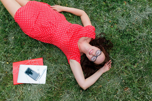 Plus size woman lying on the grass and relaxing. Top view - Photo, image