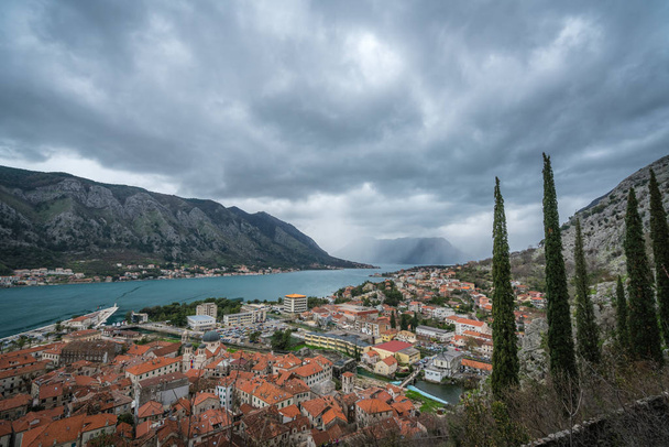Homes and houses in Kotor town and stunning landscape of the Bay of Kotor, as seen from the trail to the Chapel of Our Lady of Salvation, Montenegro - Photo, Image