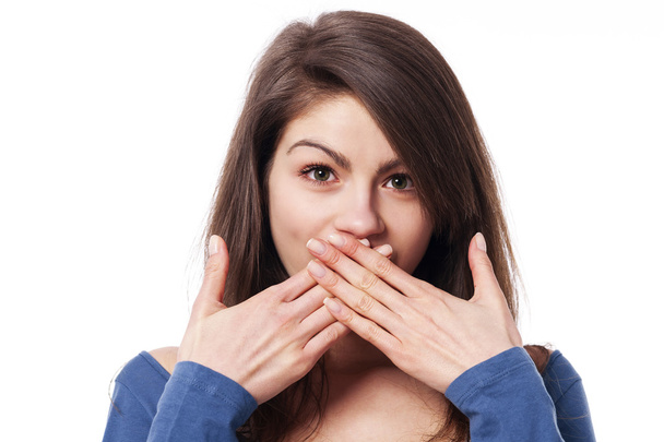 Woman with hands covering mouth - Photo, Image