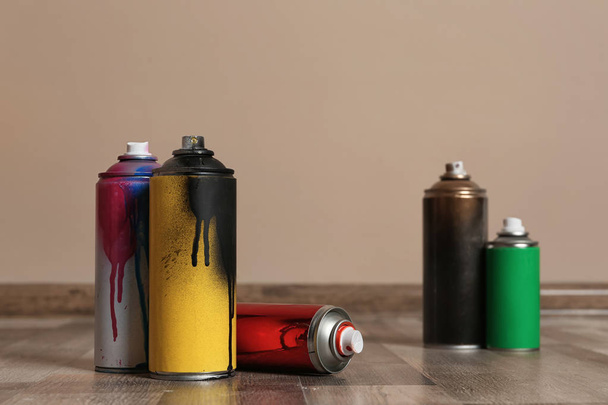 Used cans of spray paint on floor indoors. Space for text - Fotoğraf, Görsel