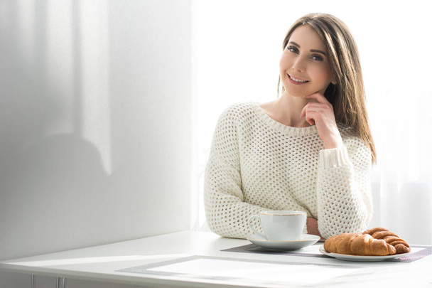 happy girl has breakfast  with croissants and coffee - Fotoğraf, Görsel
