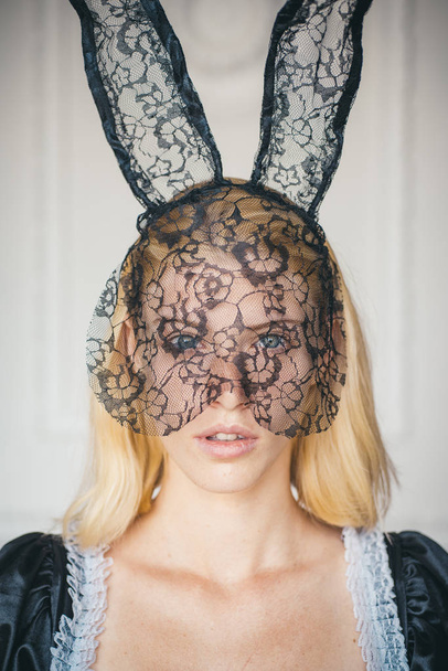 Attractive young woman wearing bunny ears. Fashion portrait of beautiful sensual woman on a white background. Expression face. Rabbit easter. - Valokuva, kuva