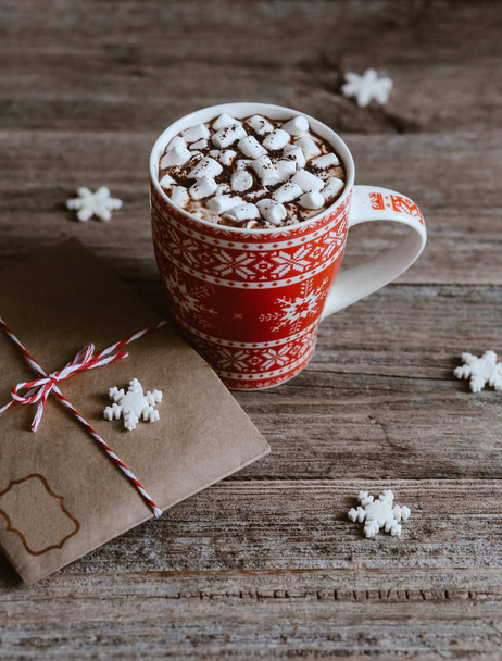 cocoa with marshmallows in a festive Christmas cup and an envelope with a letter to Santa - Фото, изображение