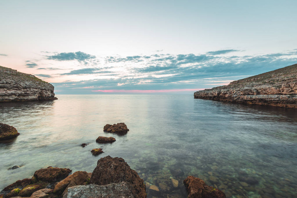 Brilliant vacation destination beach sunrise and sea cliffs background - Фото, изображение