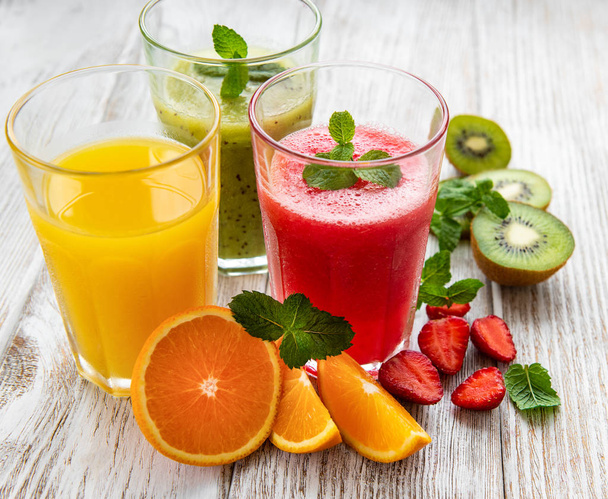 Healthy fruit smoothies on a old wooden table - Photo, Image