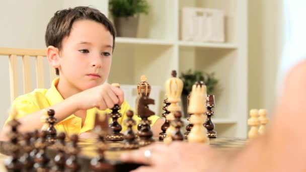 Young Boy With Chess Game - Materiał filmowy, wideo