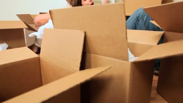 Caucasian Couple Surrounded by Moving Boxes - Footage, Video