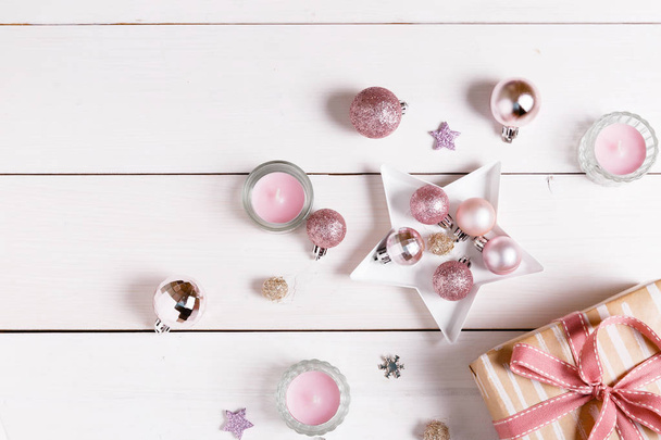 Christmas composition. Xmas pink decor holiday ball with ribbon on white background. - Foto, imagen